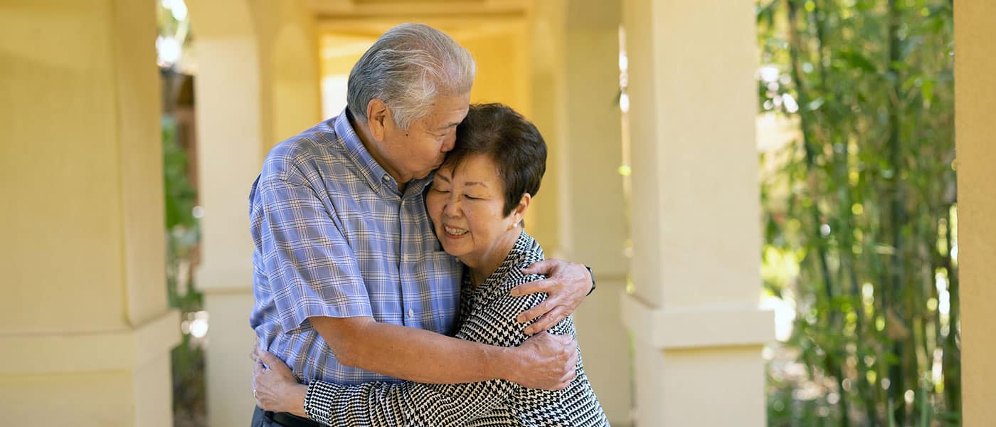A couple embracing in the outside courtyard
