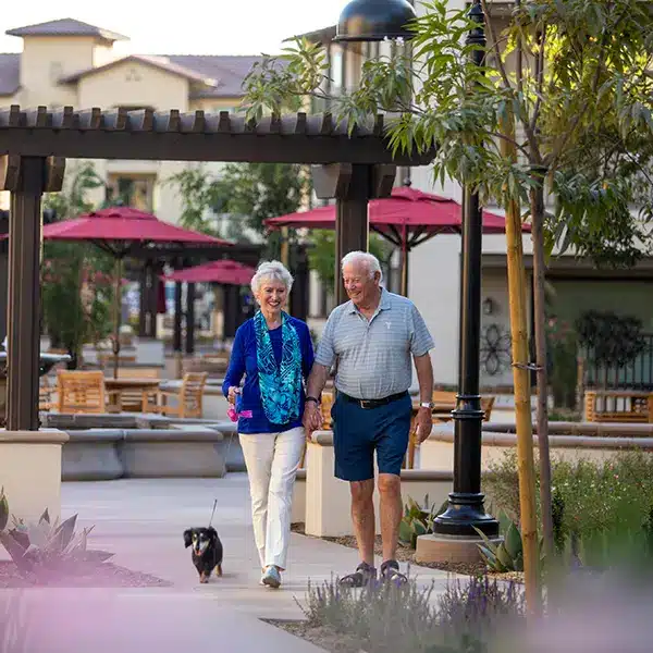 An elderly couple walking in the courtyards at Stoneridge Creek