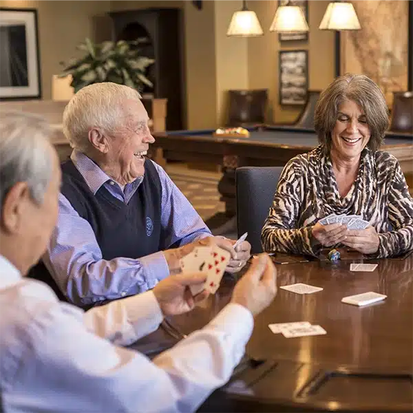 A group of elderly residents playing a card game together