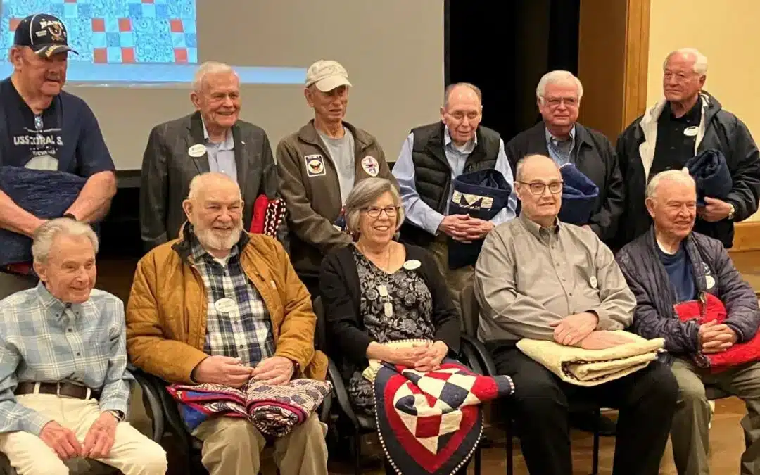 Veterans day at Stoneridge Creek with residents sitting in a group.